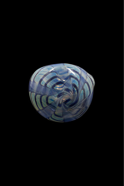 Blue and white swirled glass cannabis bowl against a black background.