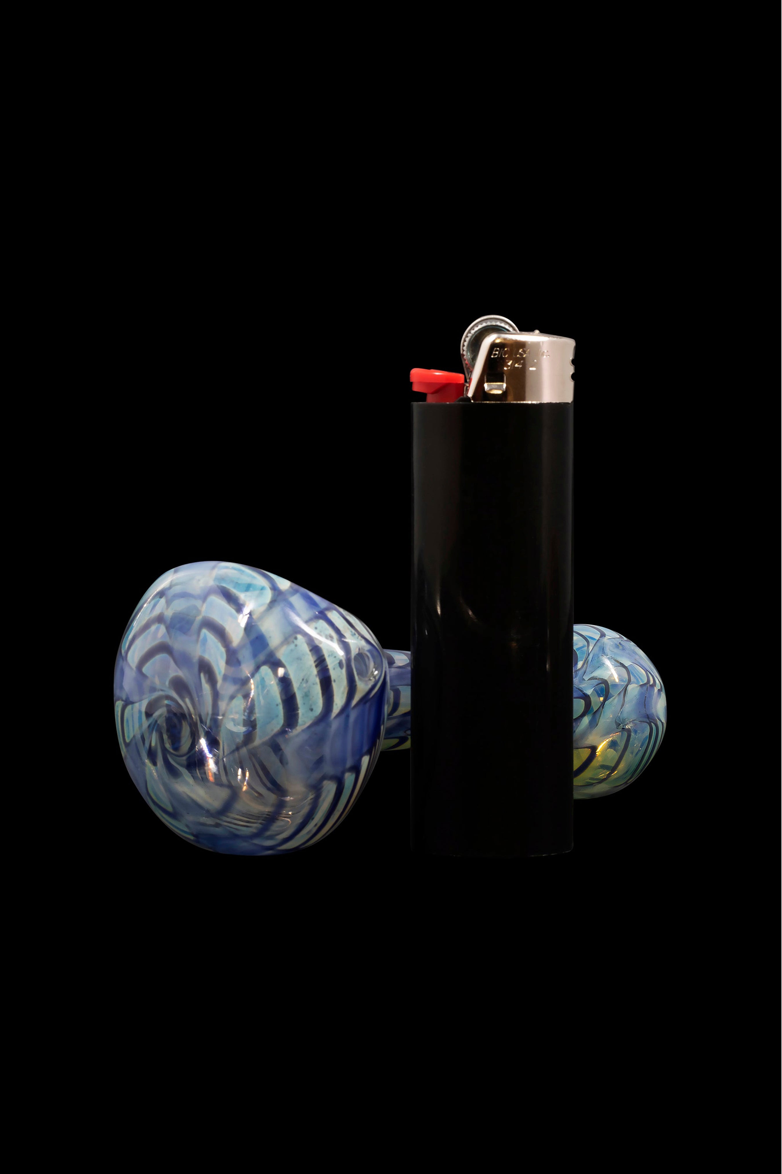 Glass cannabis pipe and lighter isolated on black.
