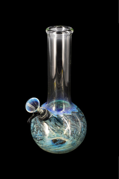 Glass water pipe with blue and white swirling patterns, isolated on a black background.