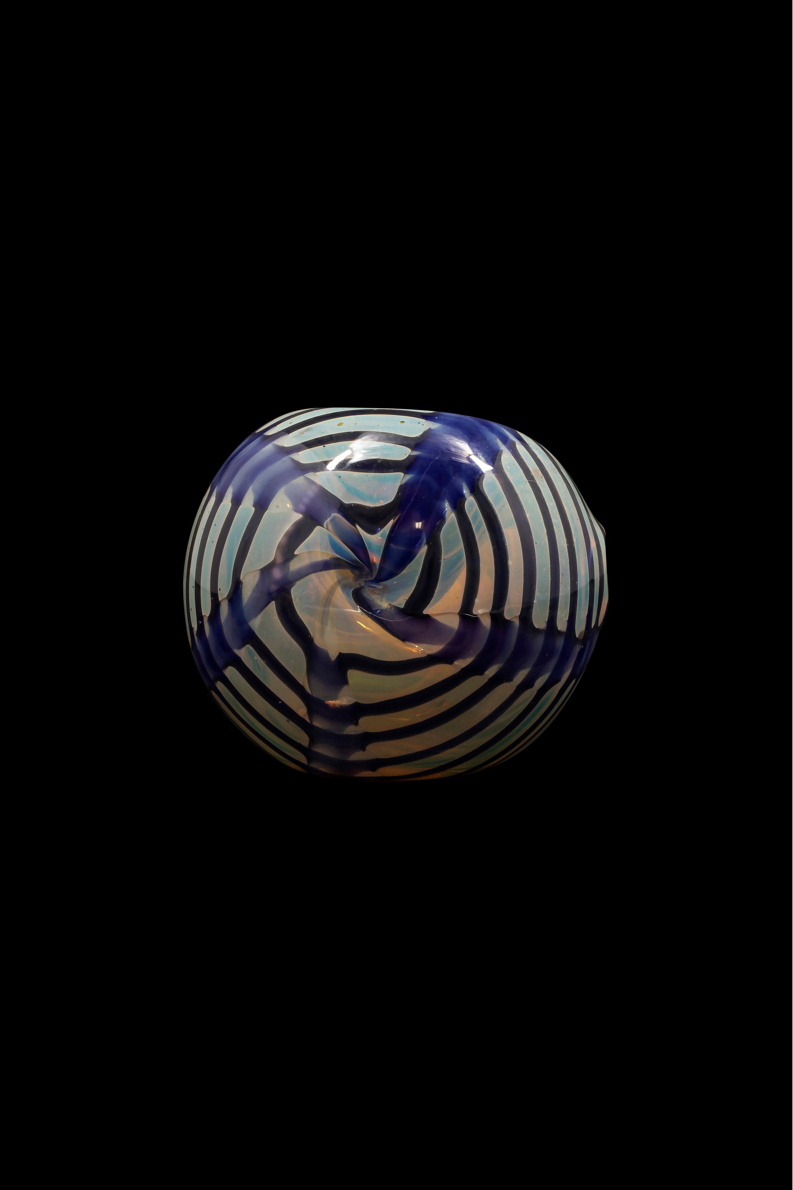 Glass cannabis pipe with swirling blue and white pattern on black background.