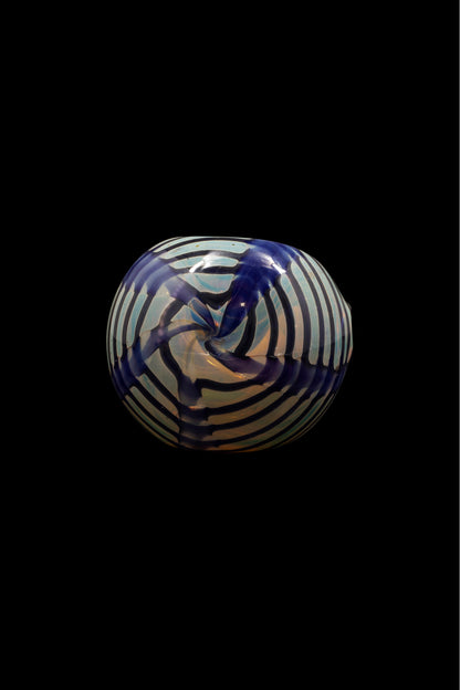 Glass cannabis pipe with swirling blue and white pattern on black background.