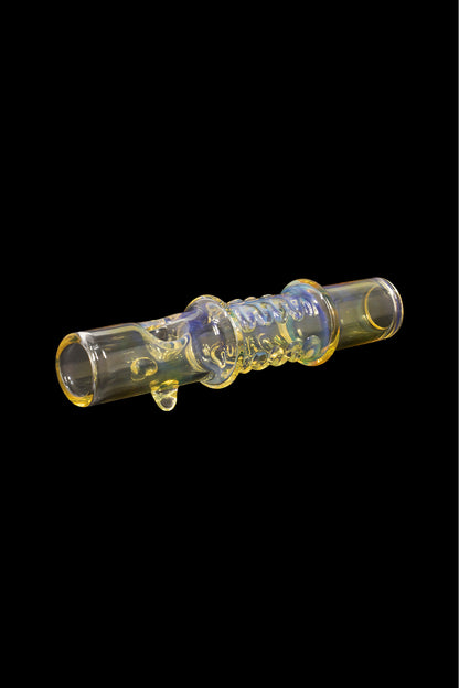 A glass cannabis oil burner pipe with iridescent blue and gold detailing, isolated on a black background.
