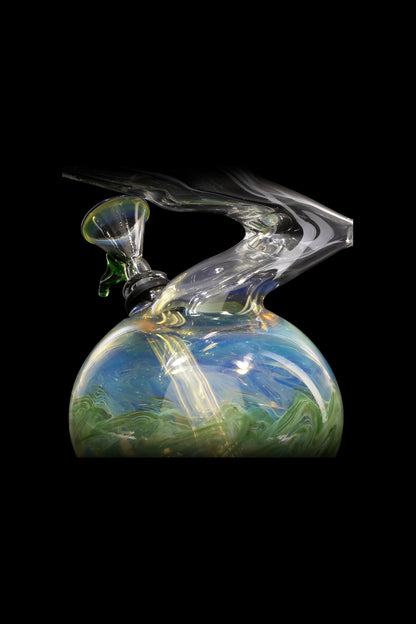 Glass water pipe with blue and green swirling patterns, emitting smoke against a black background.