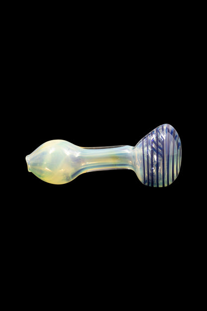 Iridescent glass pipe with blue and white striped bowl against a black background.