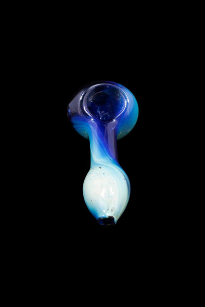 Glass pipe with blue and white swirling patterns against a black background.