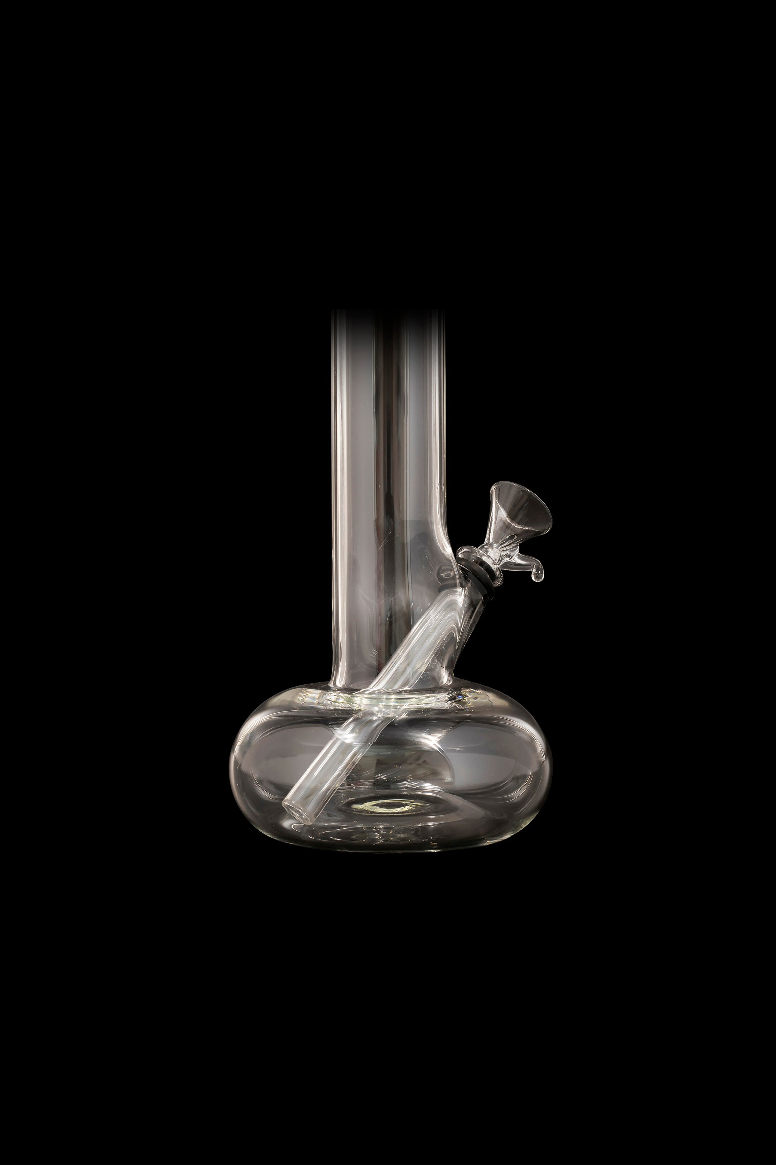 Glass water pipe, also known as a bong, against a black background.