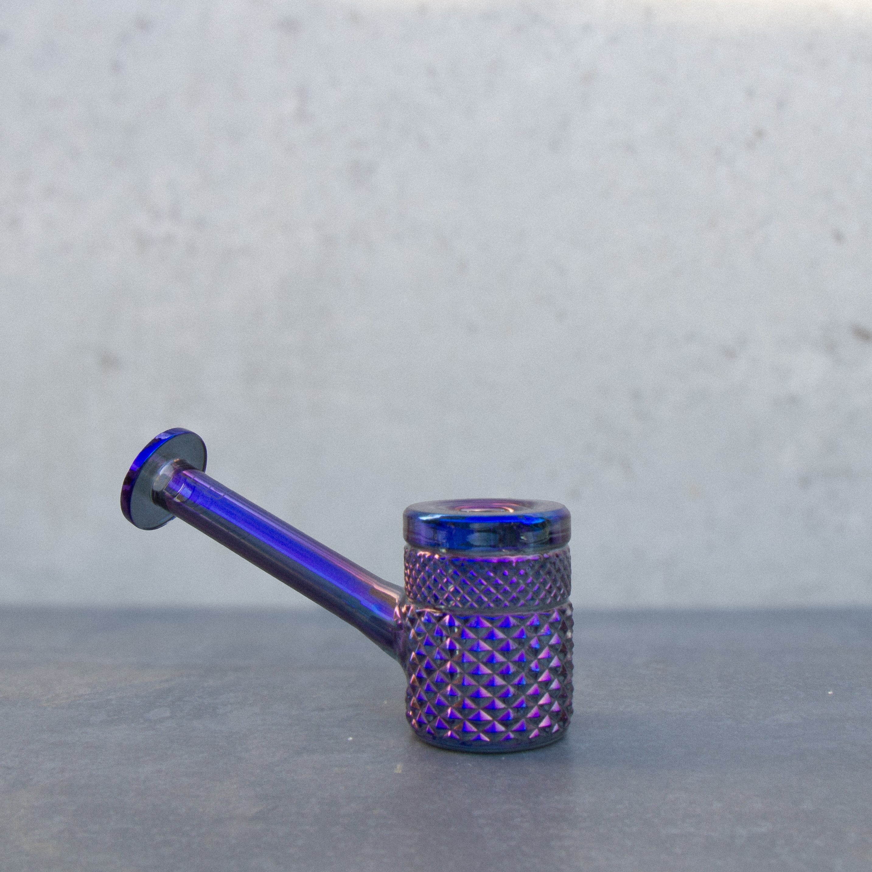 Purple glass oil rig with textured body and mouthpiece.