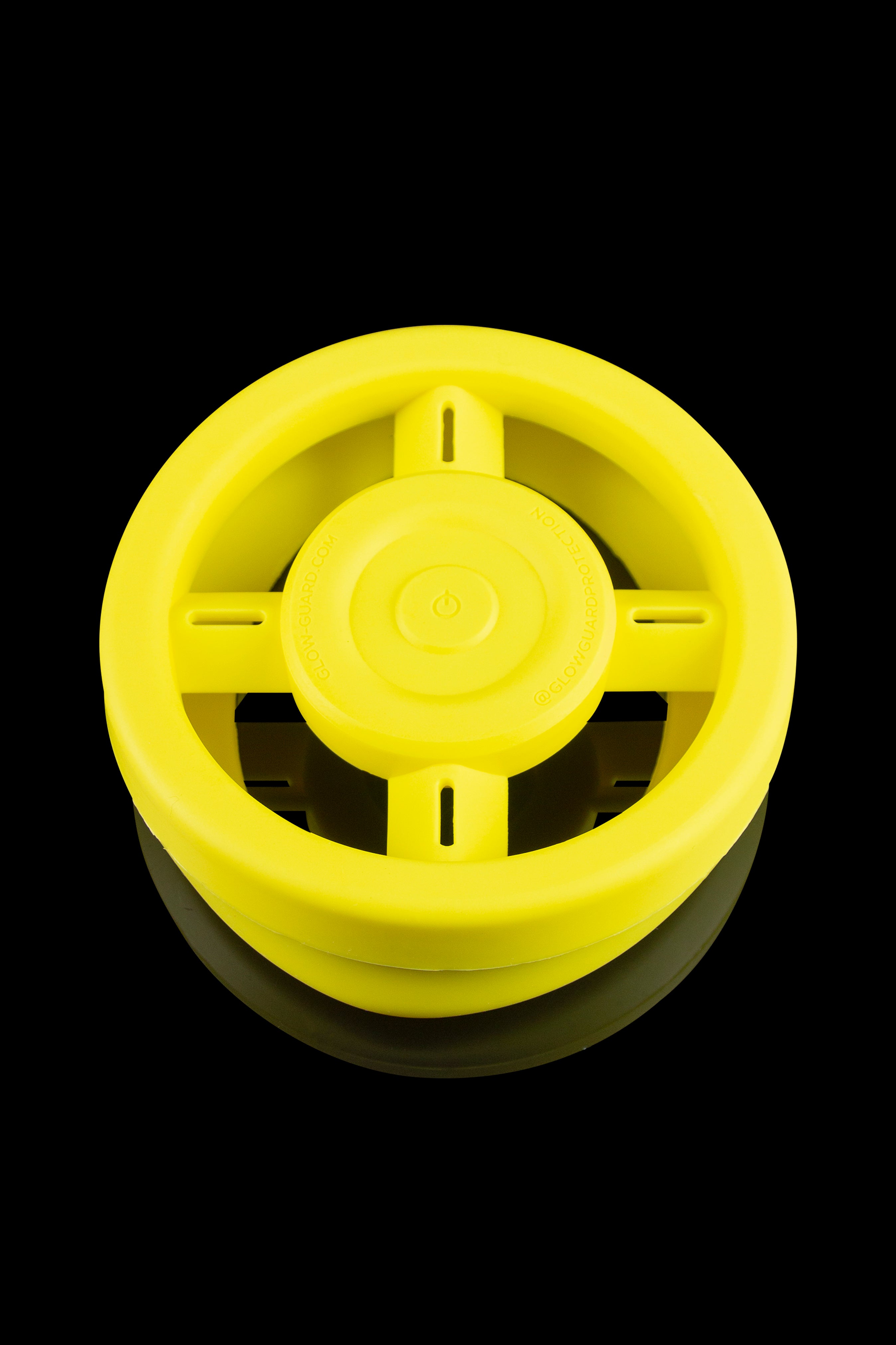 Yellow electric dab rig with visible heating element and central control button.