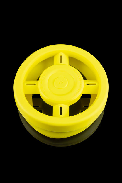 Yellow electric dab rig with visible heating element and central control button.