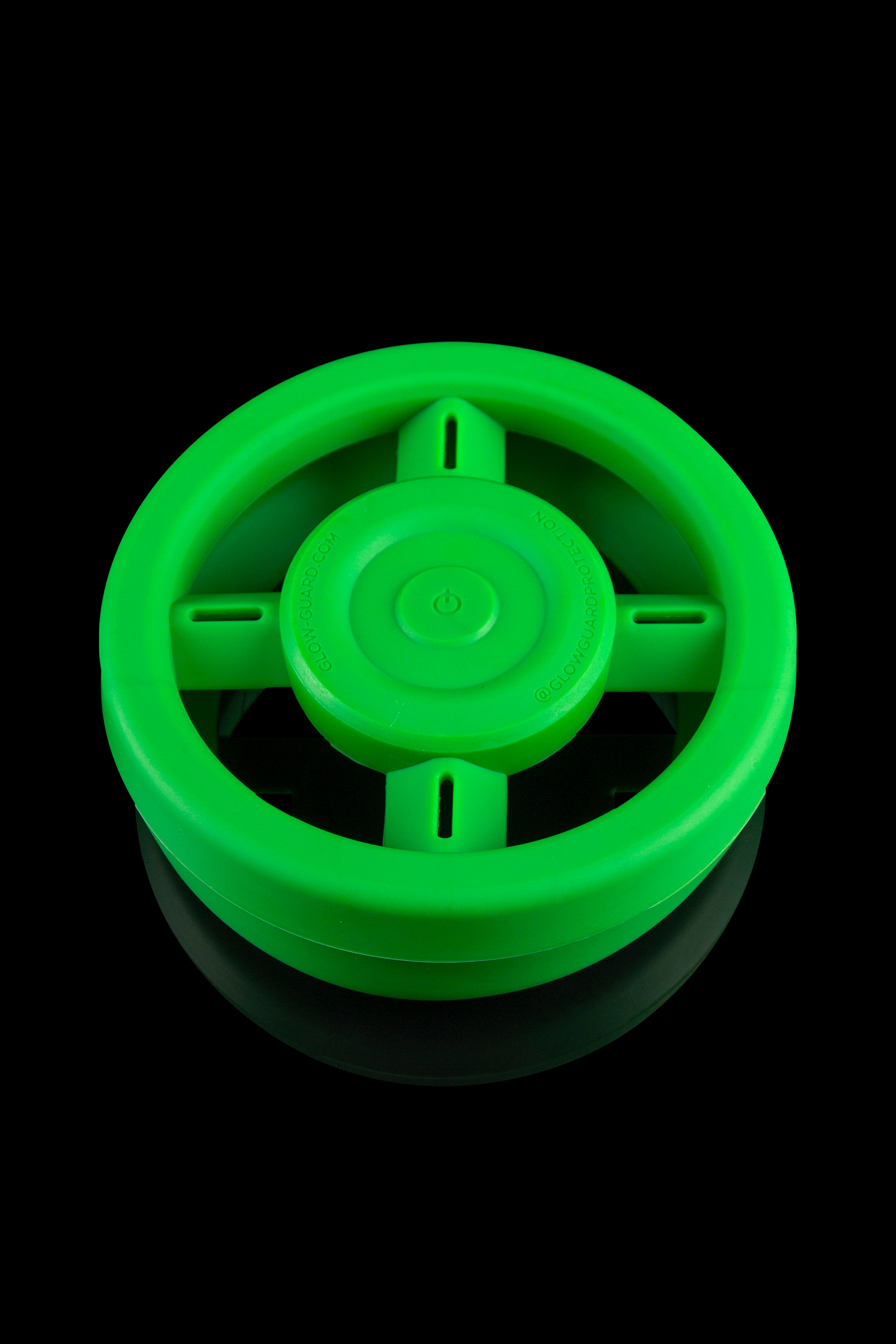 Bright green silicone cannabis storage container with a power button symbol on the lid.