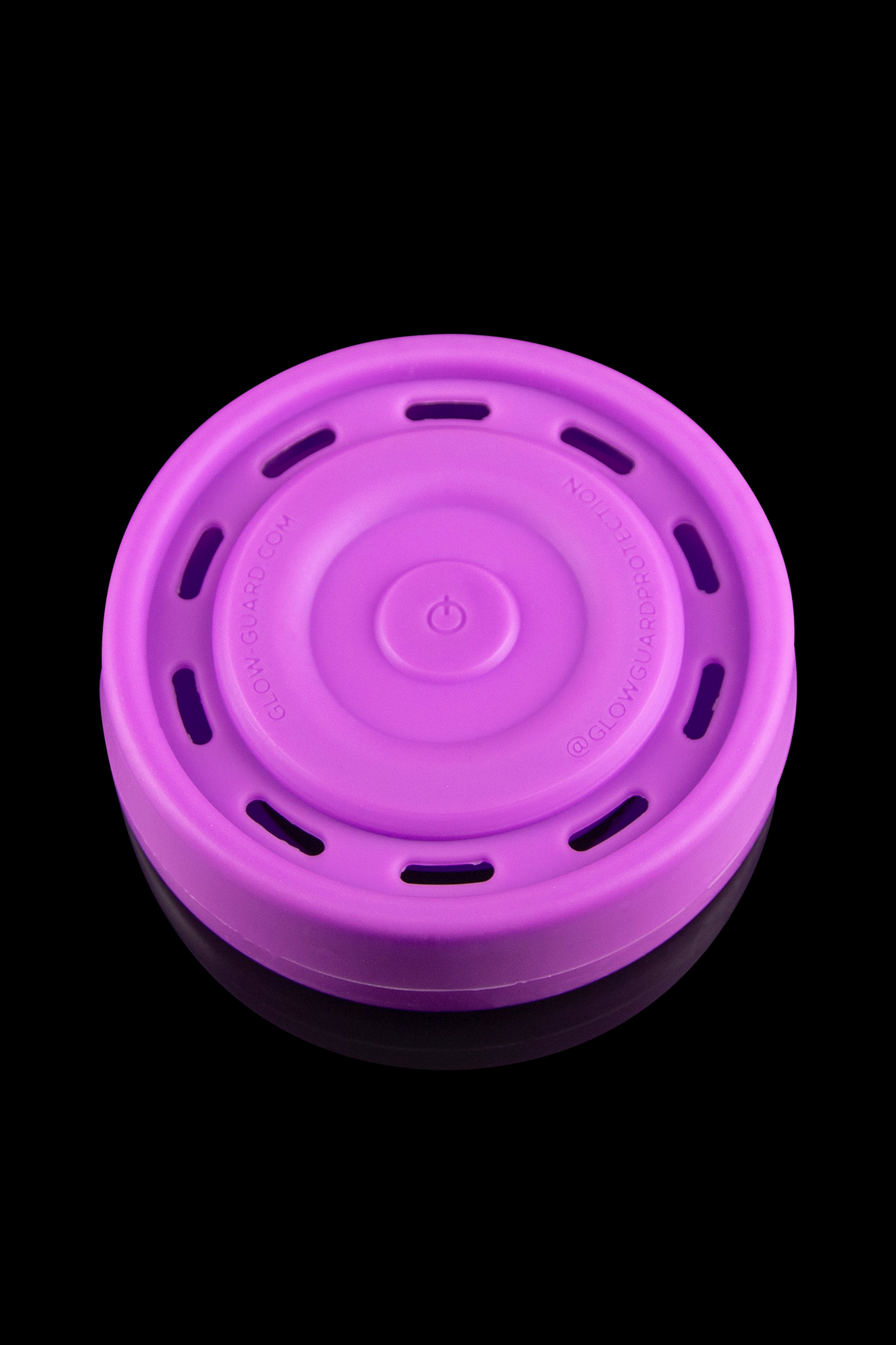 Purple silicone container for cannabis concentrates, with a textured lid and visible branding.