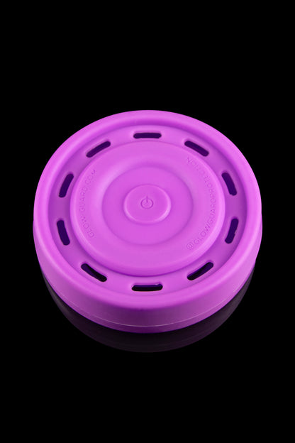 Purple silicone container for cannabis concentrates, with a textured lid and visible branding.