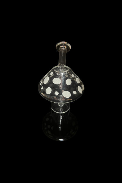 Glass mushroom-shaped oil rig with polka dots, isolated on black.