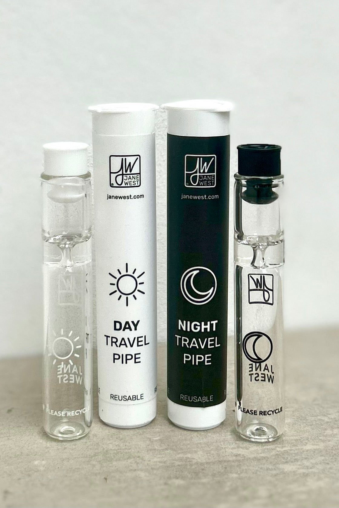 Three glass “travel pipes” for cannabis use, labeled “Day Travel Pipe” and “Night Travel Pipe” with sun and moon icons, positioned on a white background.