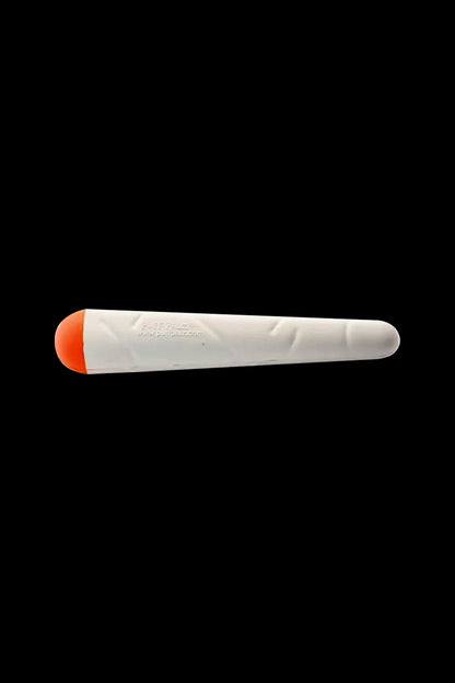 Angled side view of a white toy with an orange rounded tip, the Puff Palz Doggie Doob Dog Toy centered on a black background.