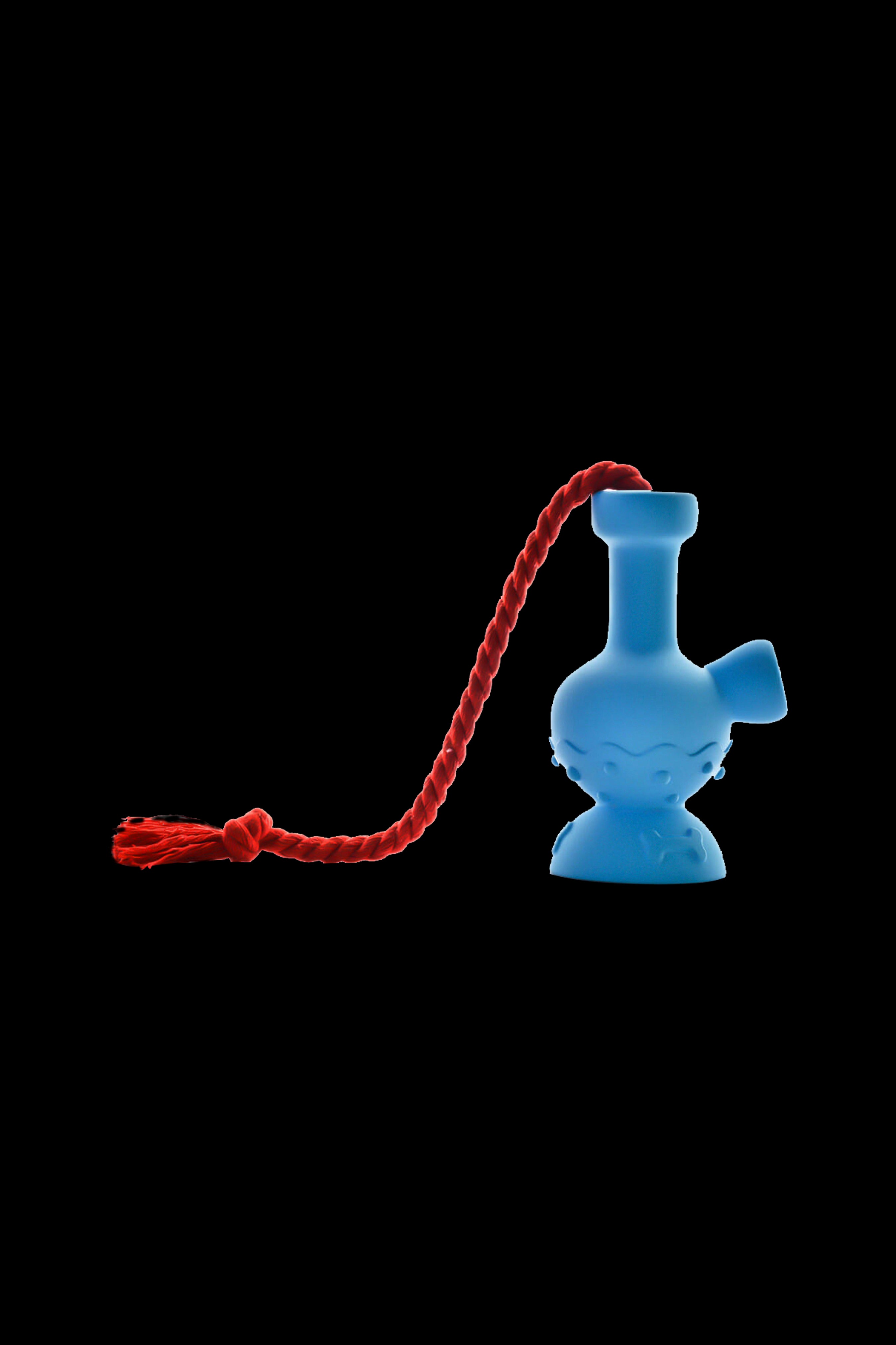 Blue glass bubbler with red cord isolated on a black background.