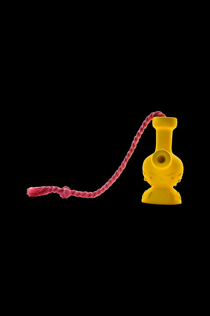 Yellow glass bubbler with a red braided lanyard on a black background.