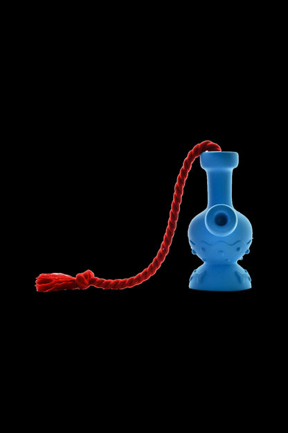 Blue glass oil rig with a red twisted lanyard against a black background.