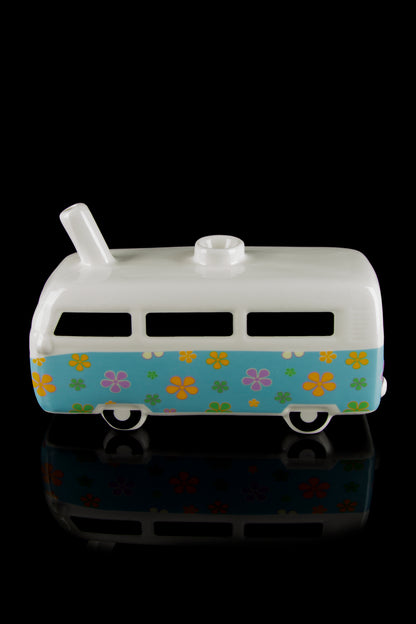 Retro-style ceramic van, decorated with colorful floral patterns, likely used as a discreet cannabis storage container.