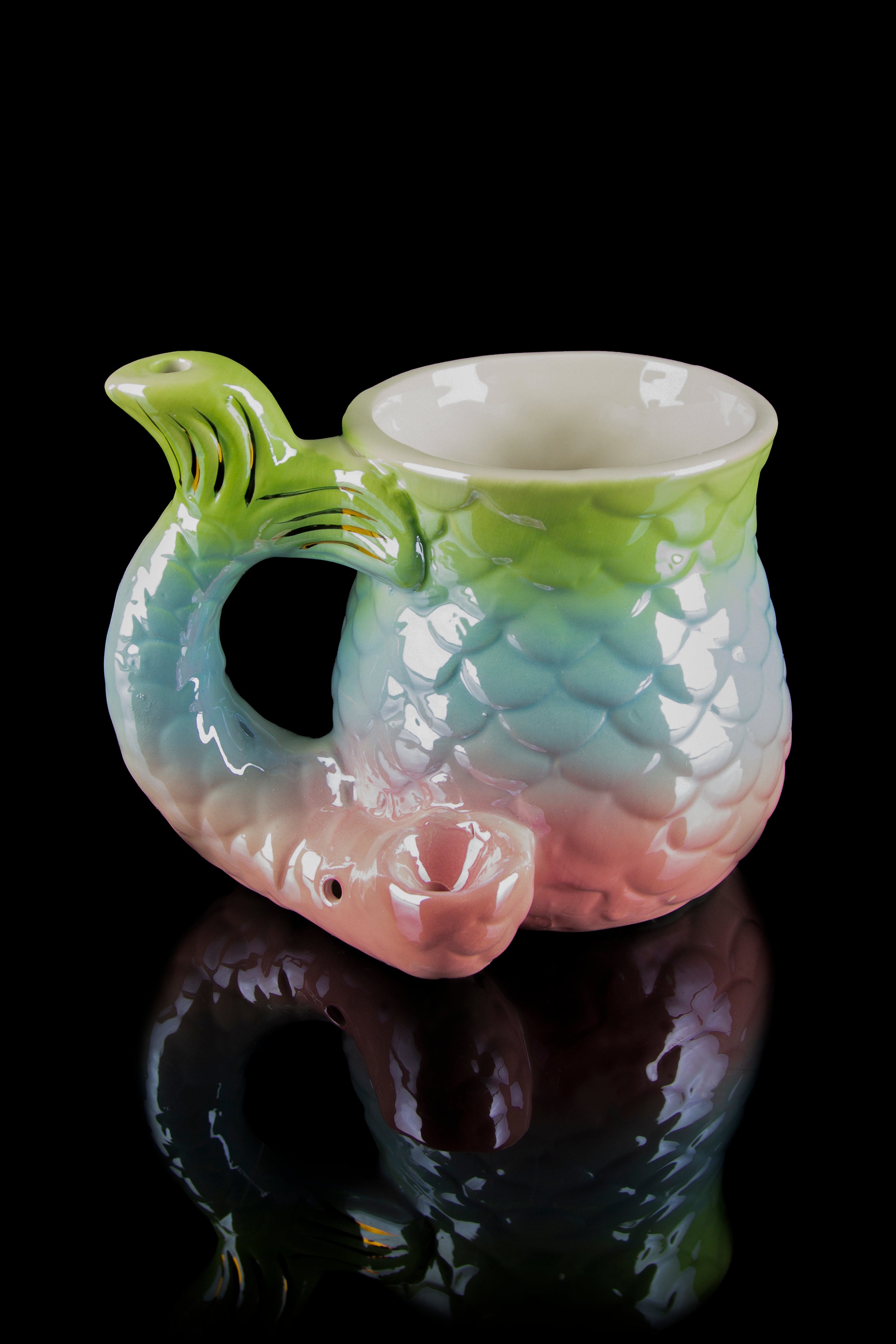 A colorful, sculpted glass water pipe shaped like a dragon’s head with a smooth, reflective surface.