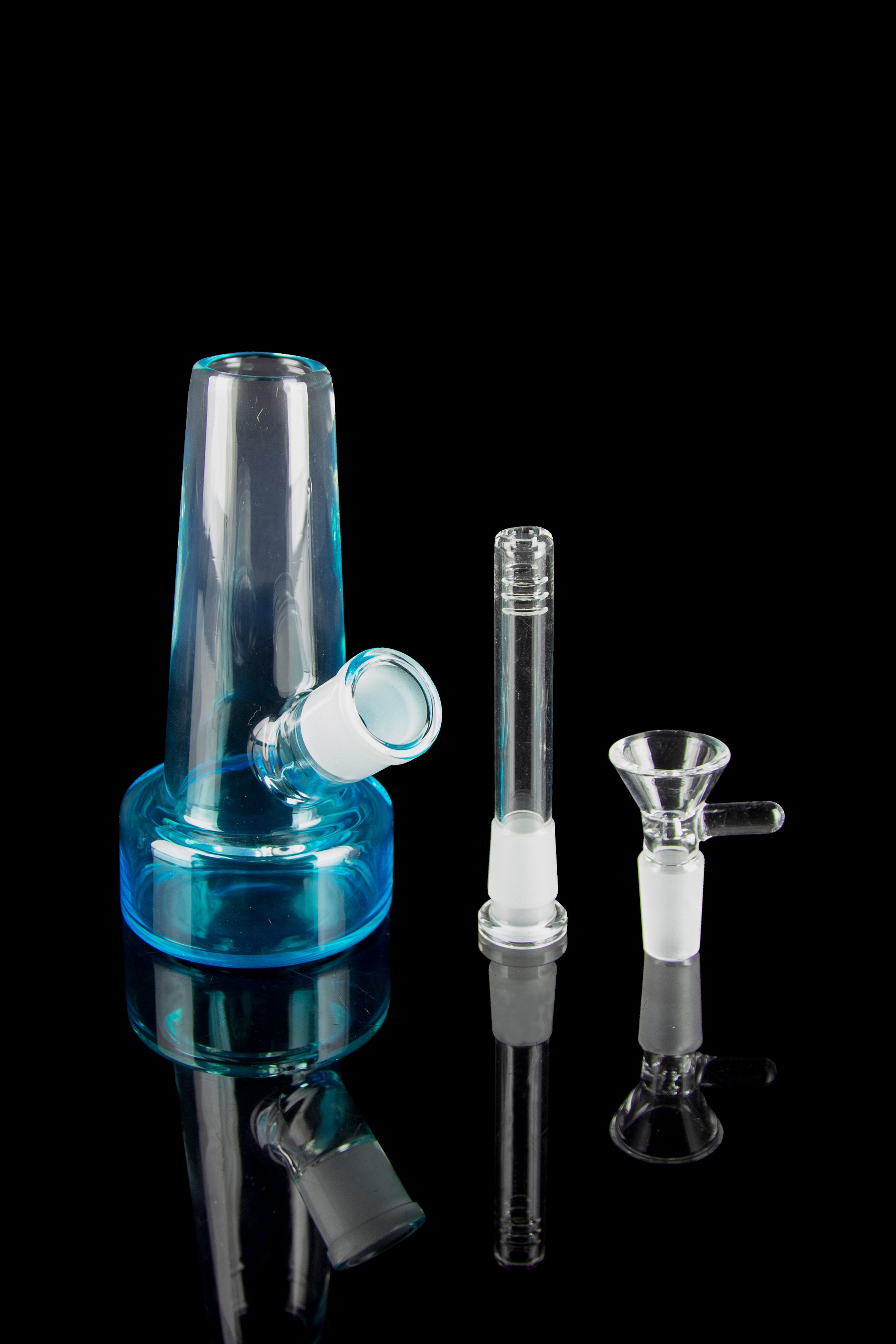 Blue glass bubbler, downstem, and bowl against a black reflective surface.
