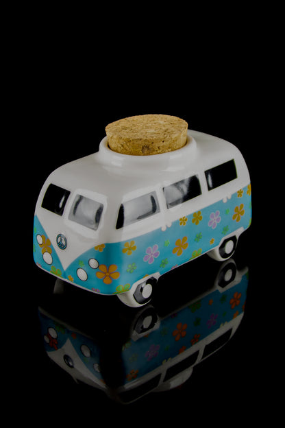 Vintage-style ceramic van-shaped storage jar with a cork lid, featuring floral designs and a peace sign, reflecting cannabis culture aesthetics.