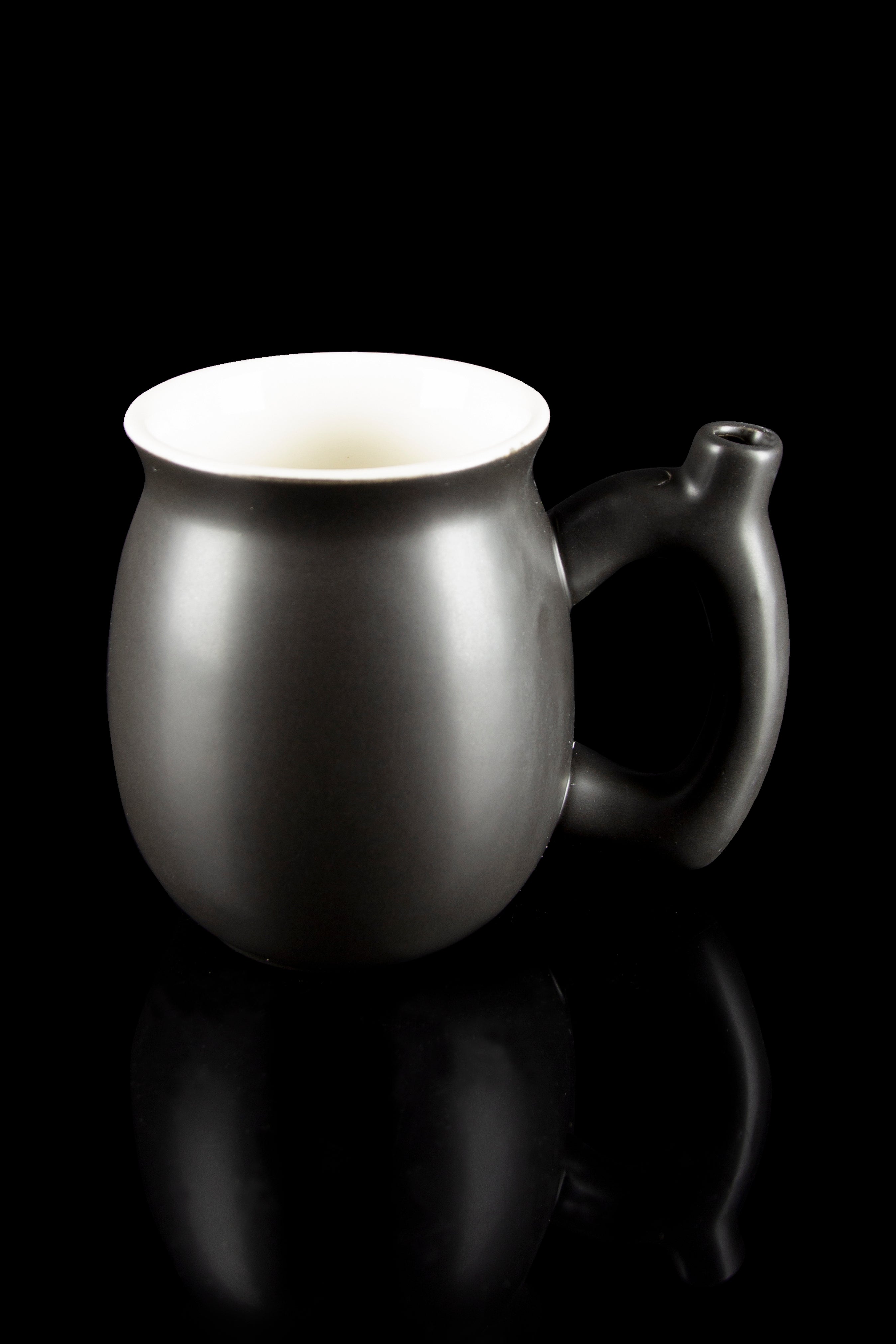 Black ceramic bubbler with a white interior, reflecting on a dark surface.