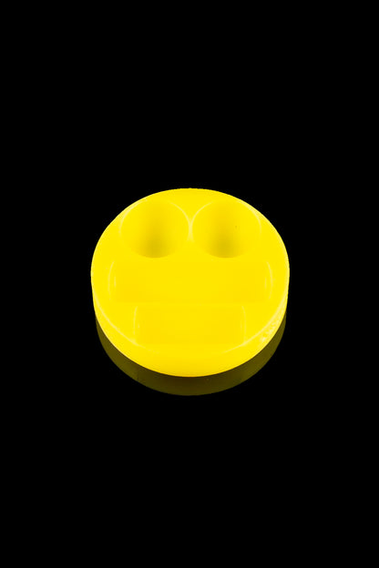 Yellow smiley face sticker or patch, likely for cannabis accessories.