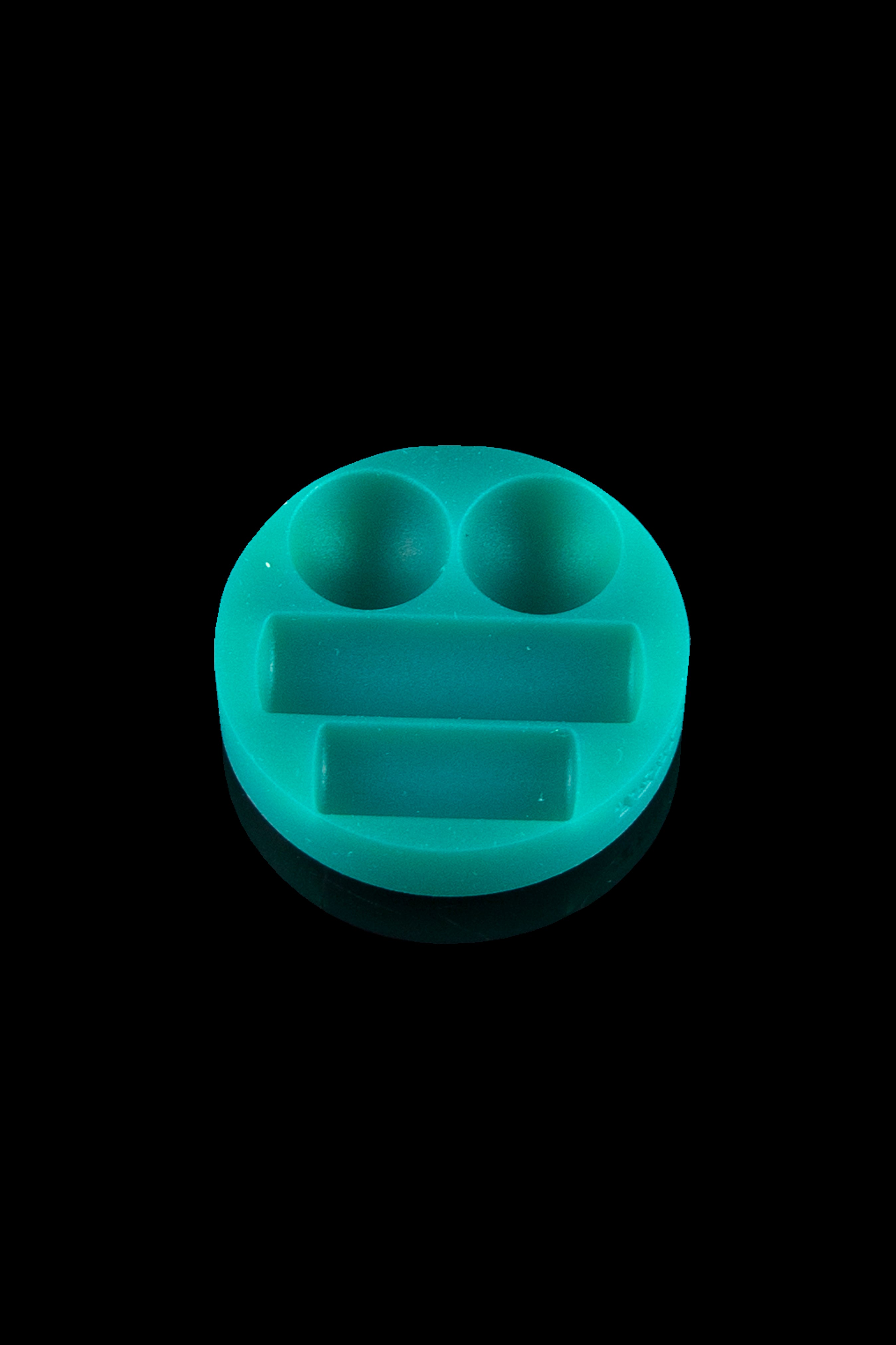 Teal silicone concentrate container with two bowls and a dab tool resting space, isolated on black.