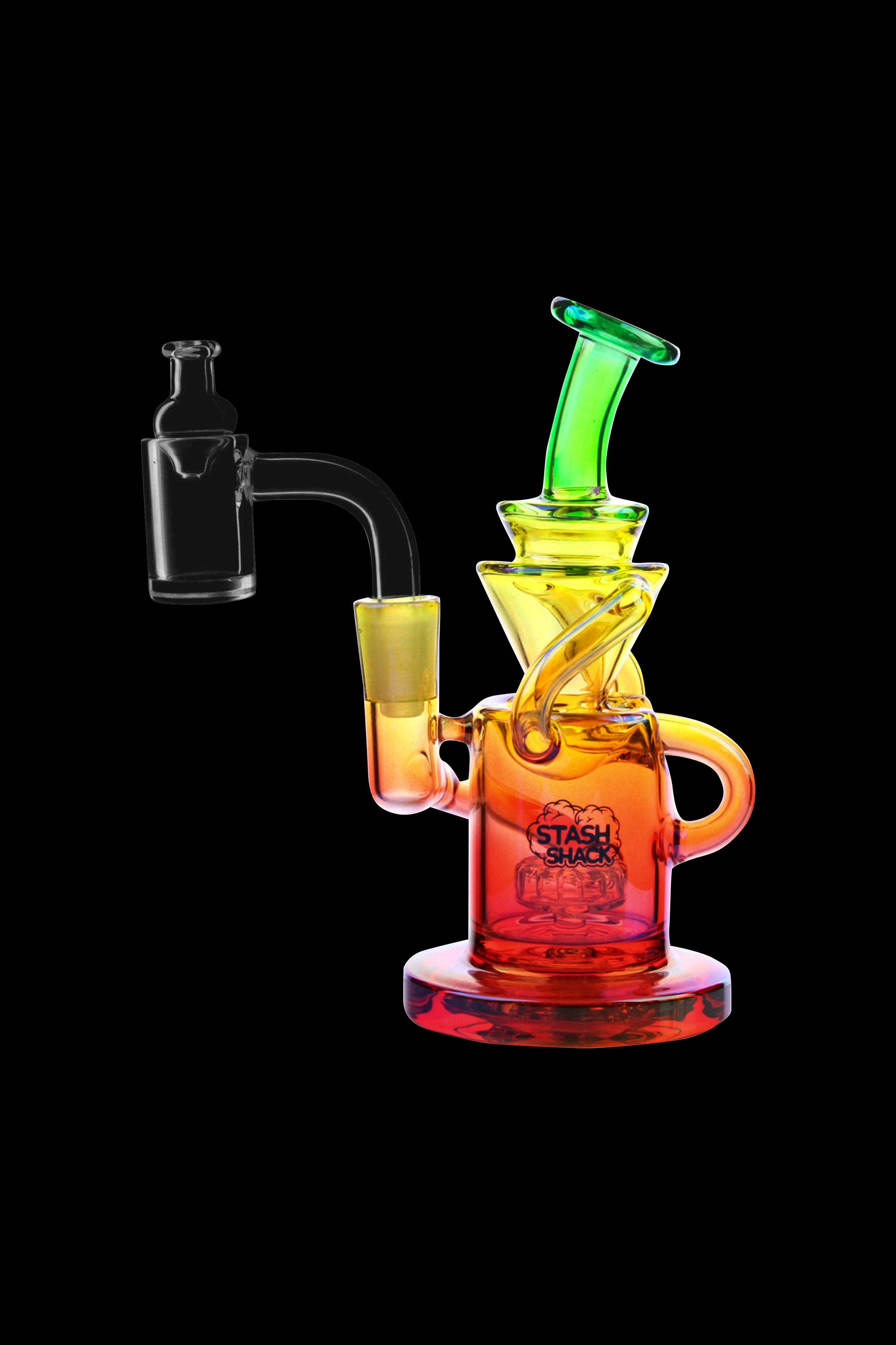 Colorful glass dab rig with accompanying nail, isolated on black.