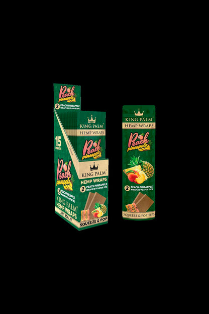 Close-up of King Palm Peach Pineapple hemp wrap boxes, displaying tropical fruit imagery and branding.