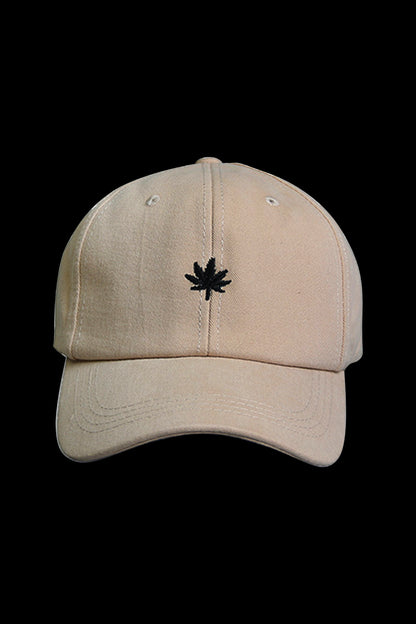 Tan baseball cap with a small, embroidered cannabis leaf on the front.