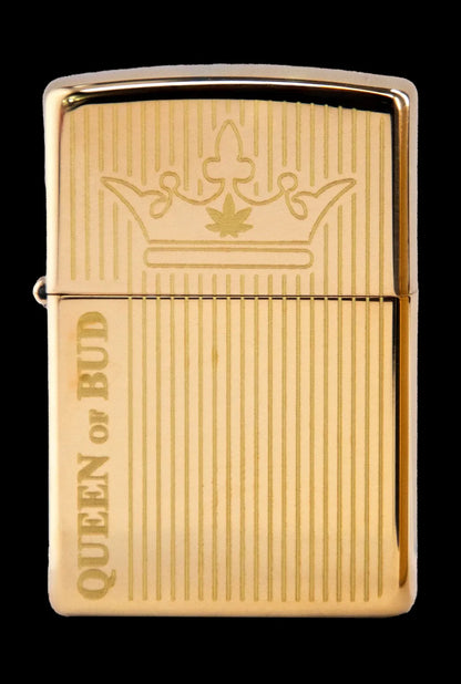 Gold Zippo-style lighter engraved with a cannabis leaf crown and the text “Queen of Bud.”