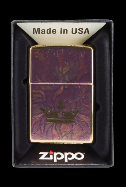 Zippo lighter with a burgundy and gold cannabis leaf design, displayed in a black box.