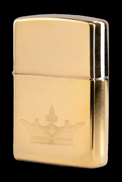 Gold Zippo lighter engraved with a cannabis leaf design.