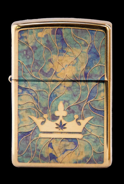 Gold Zippo lighter with a raised cannabis leaf within a golden crown design on a swirling teal and gold background.