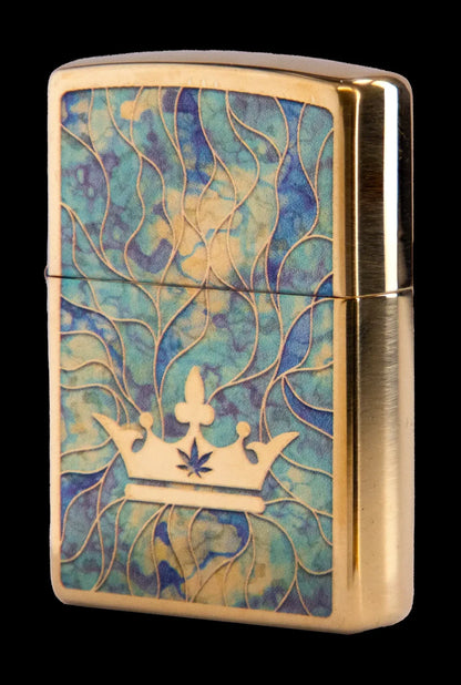 Gold Zippo lighter with a swirling teal and gold pattern and a crown featuring a cannabis leaf.