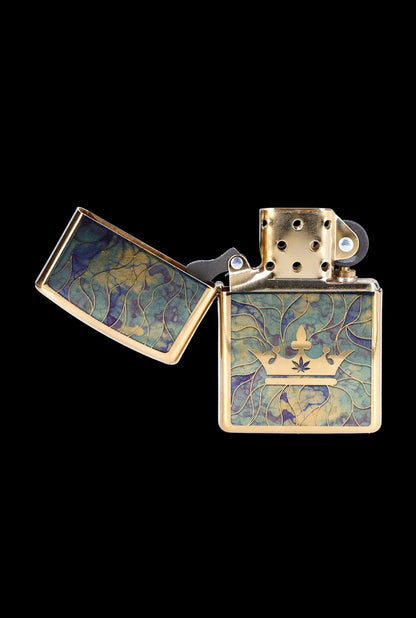 Gold lighter with a cannabis leaf crown design, open and displayed on a black background.