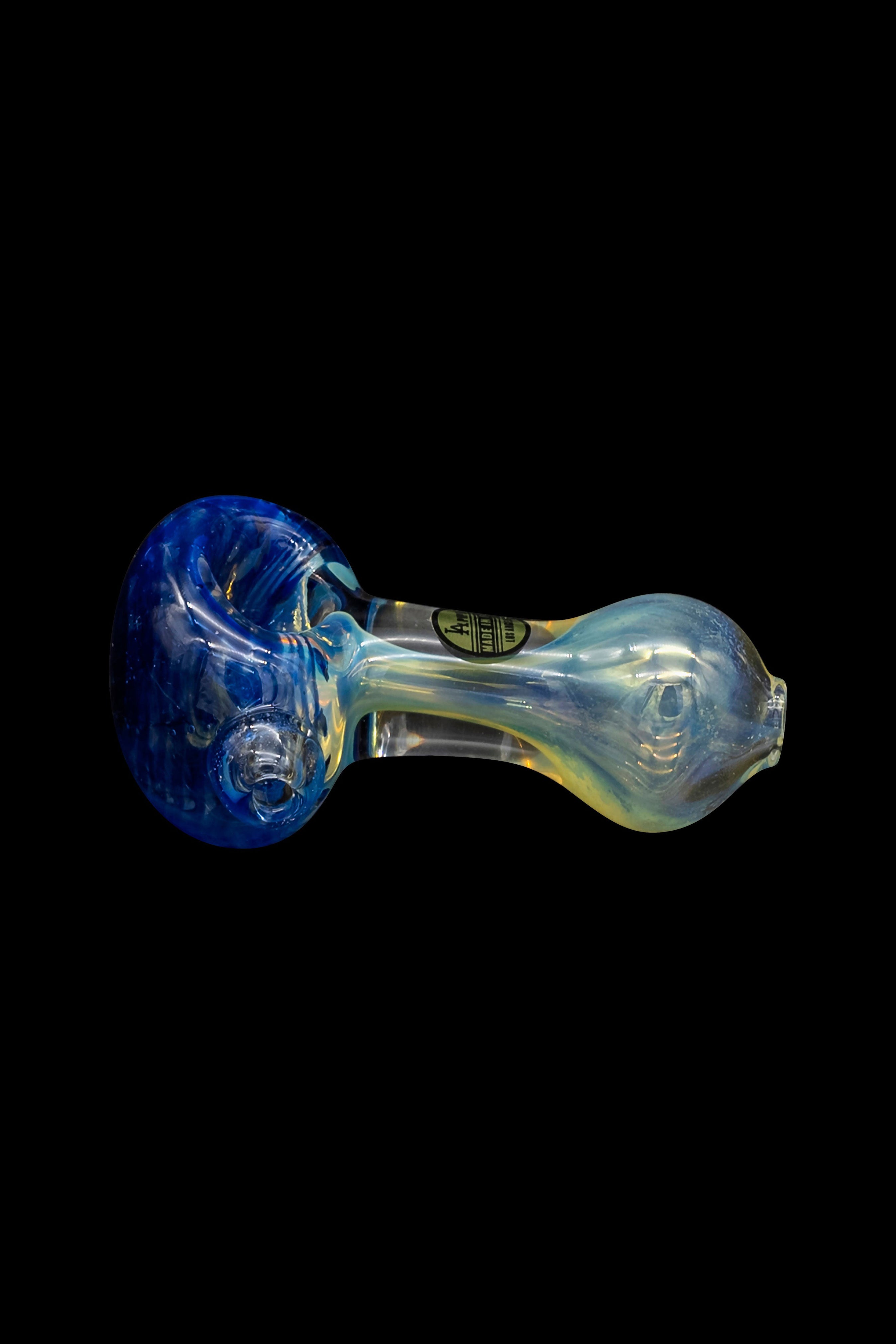 Glass pipe with blue and iridescent green swirls, isolated on a black background.