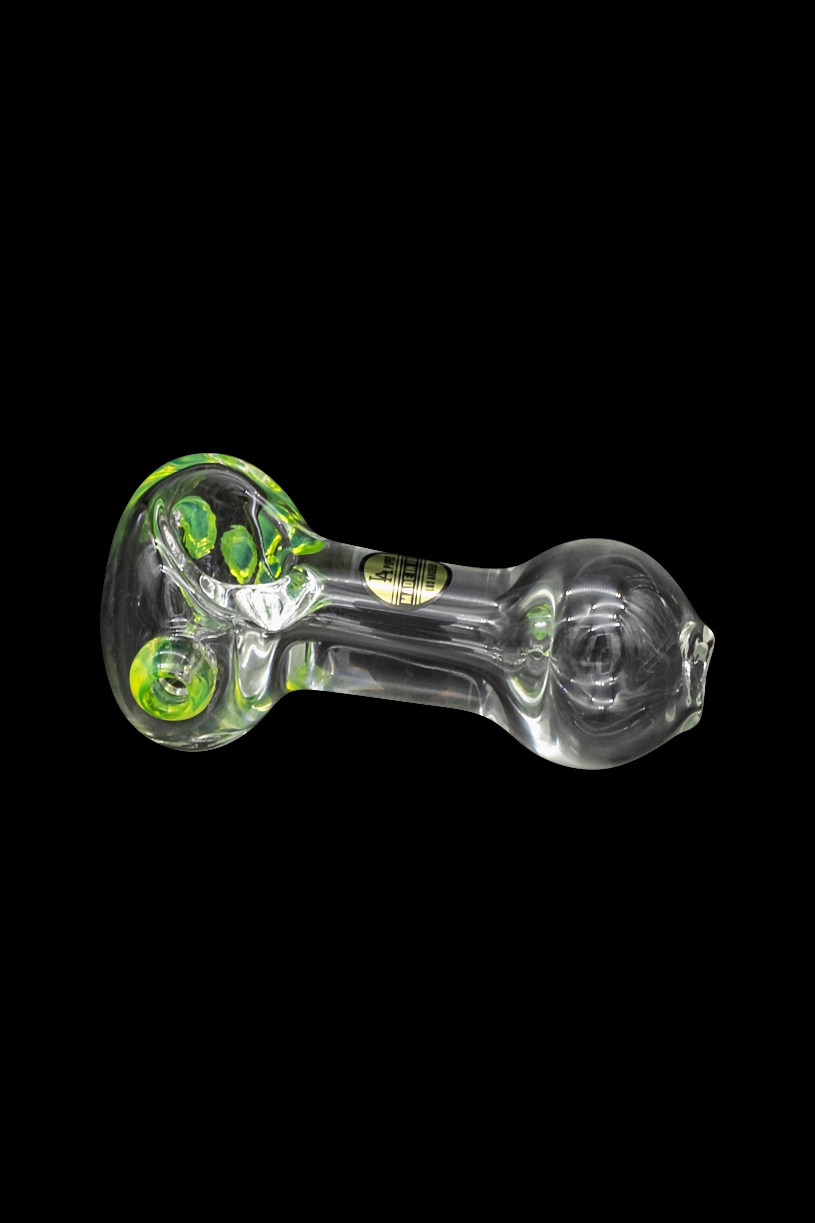 Clear glass pipe with green accents, isolated on black.