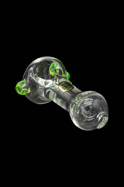 Green glass cannabis pipe with bubble accents on a black background.