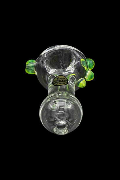 Green glass bubbler pipe with detailed sculpting and a round base.