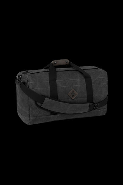Black waxed canvas duffel bag with leather straps, designed for discreet cannabis accessory storage.