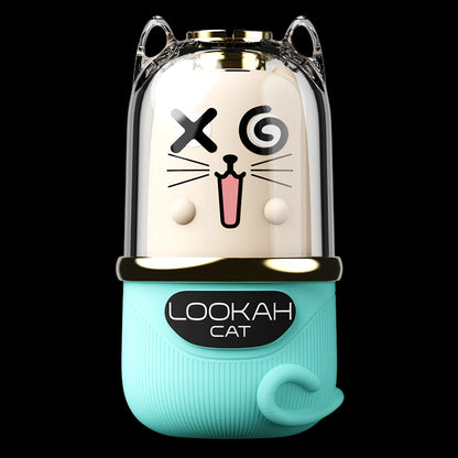 Close-up front view of the Lookah Cat Vaporizer showing a clear dome with a playful cat face and a camel-colored inner core above a teal base.