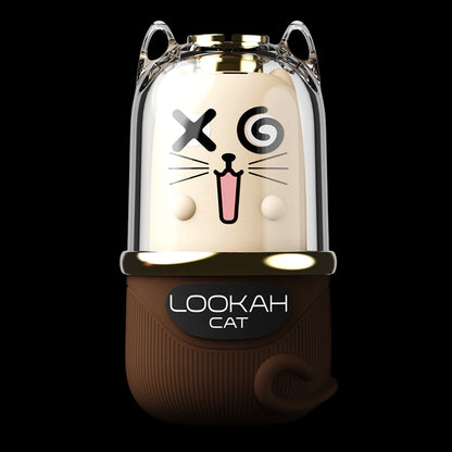 Center close-up of the Lookah Cat Vaporizer showing a clear domed top with cat ears and a cartoon cat face over a brown body.