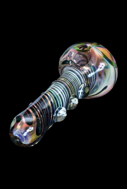 Iridescent glass smoking pipe with spiral pattern.