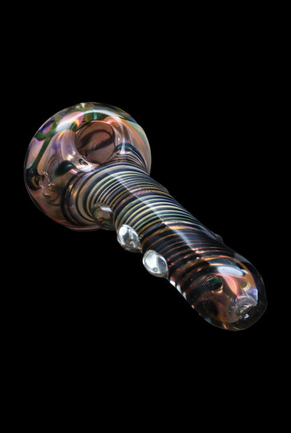 Hand-blown glass pipe with colorful swirls and raised bubbles, isolated on black.