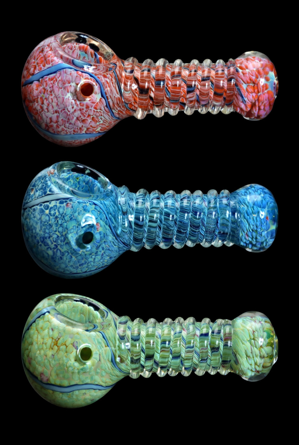 Three colorful glass pipes with intricate swirling patterns against a black background.