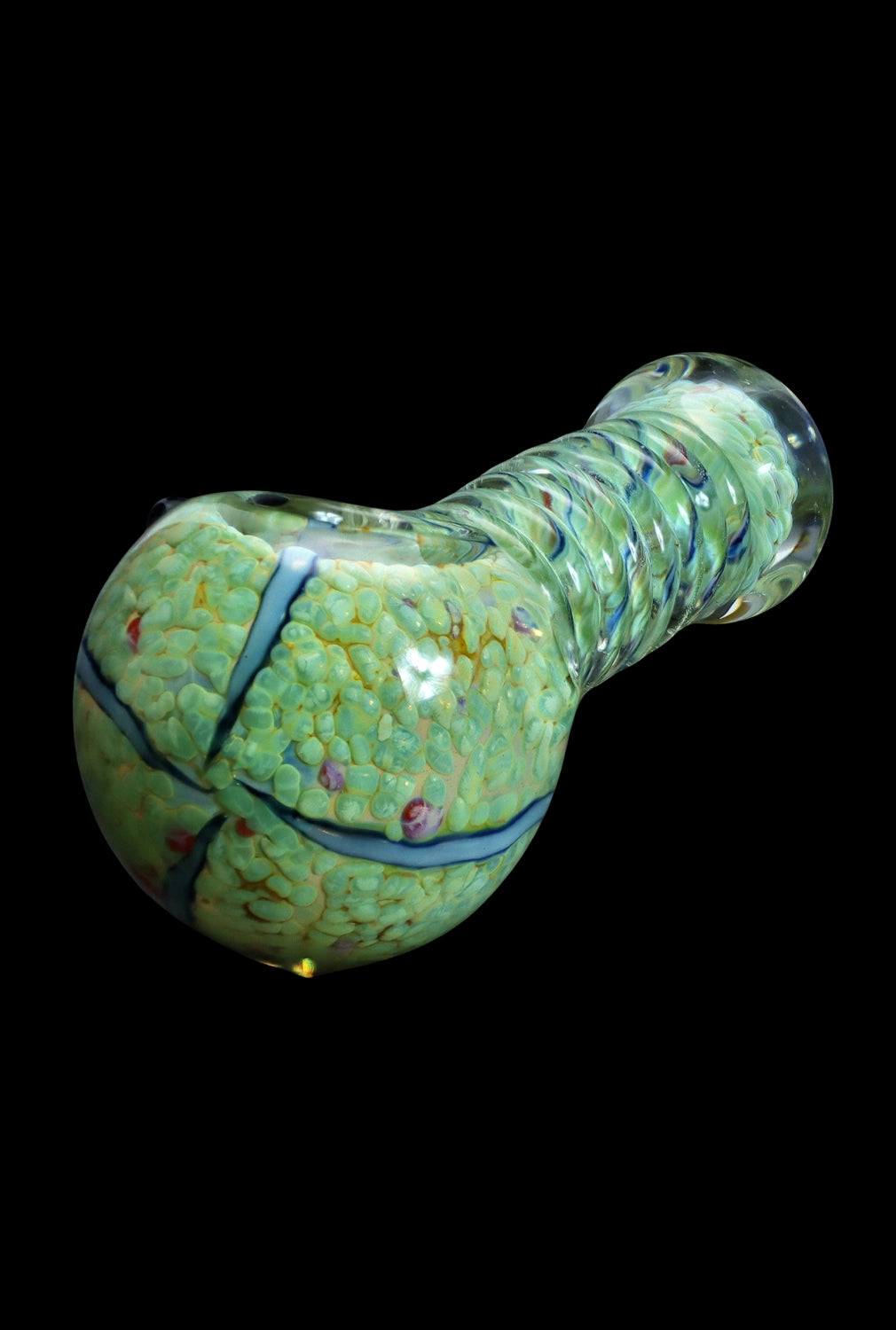 Green and teal speckled glass pipe against a black background.