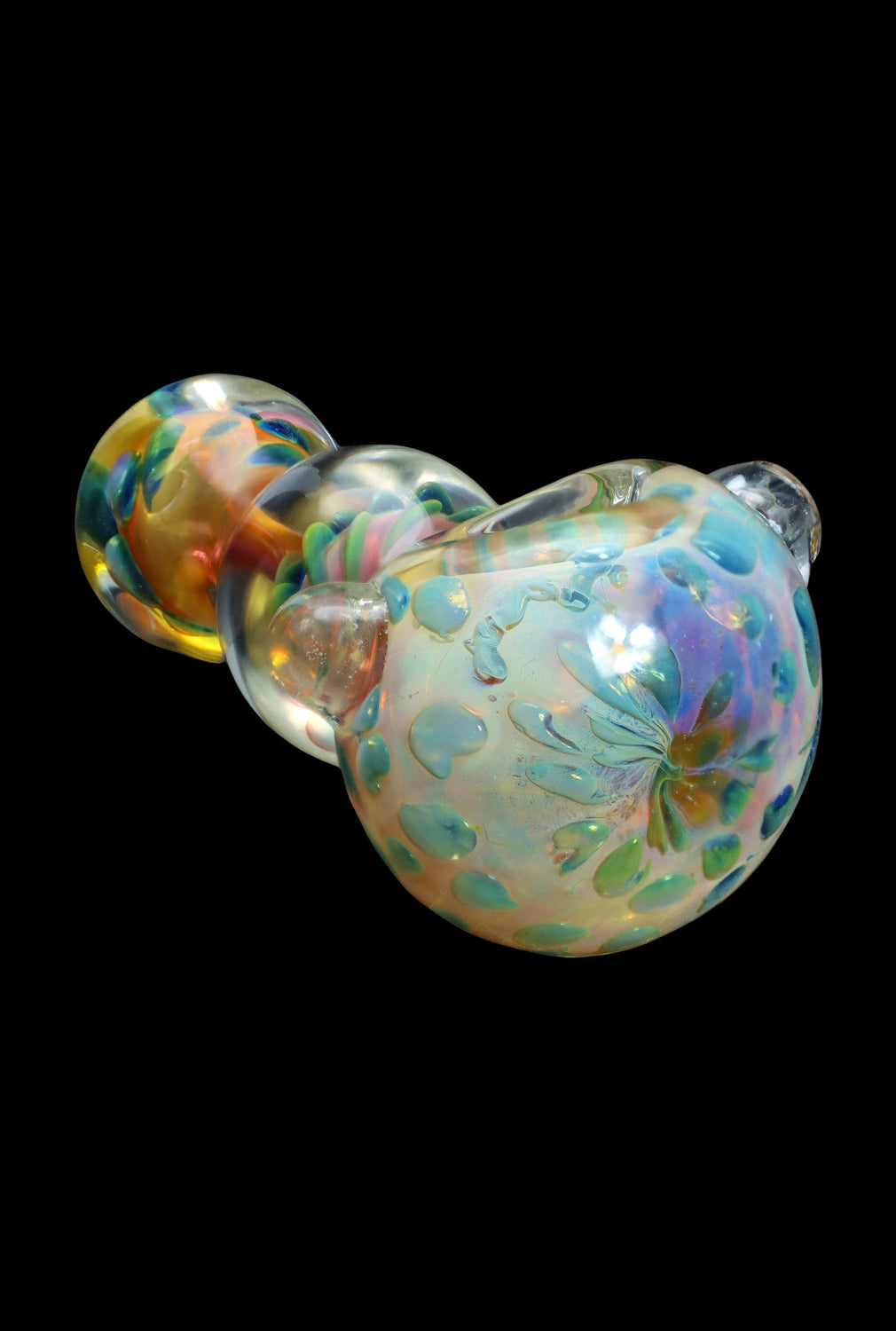 Iridescent glass cannabis water pipe with floral etching, isolated on black.